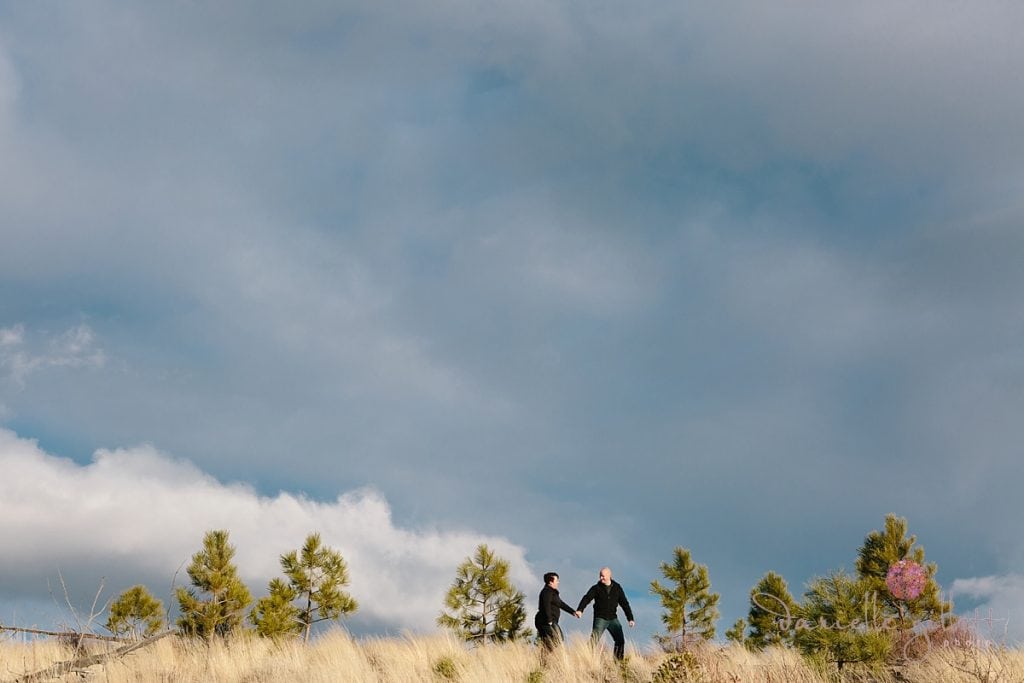 Couple walking on a mountain top from Bend Oregon engagement photos
