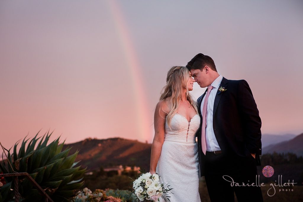 Bride and Groom with rainbow at wedding in Carmel Valley