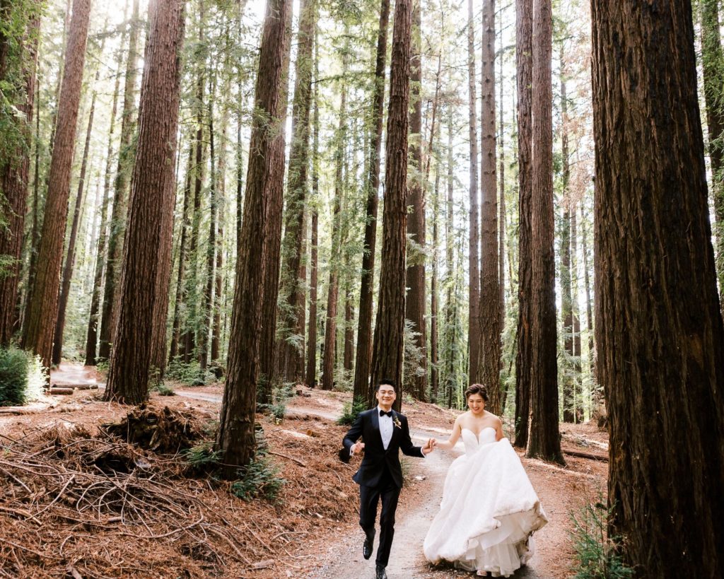 Bride and Groom running in the redwoods at Nestldown wedding